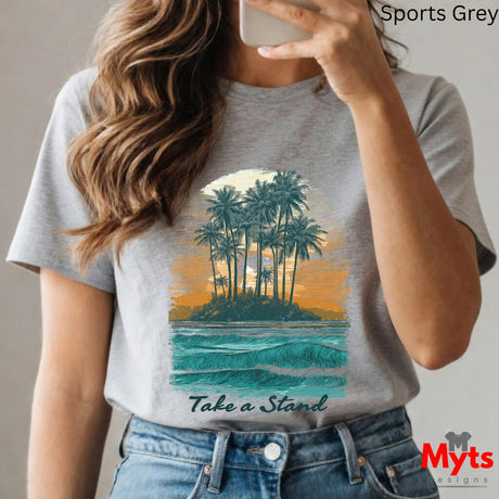 Person wearing a gray t-shirt with a tropical island design and 'Take a Stand' text, taking a selfie.