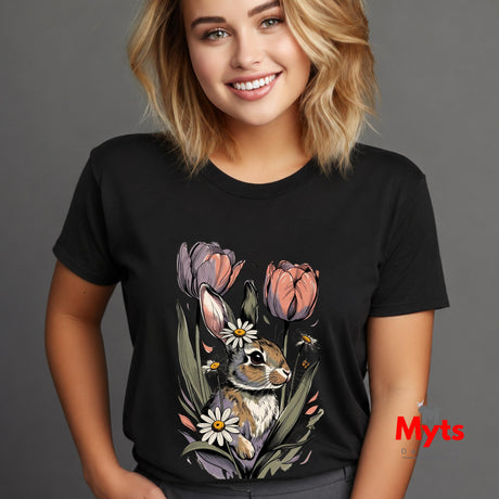 A woman wearing a black short-sleeve t-shirt with a colorful graphic of a bunny surrounded by tulips and daisies, set against a solid gray background.