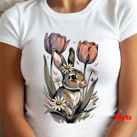 A white short-sleeve crewneck t-shirt featuring a detailed graphic print of a brown rabbit surrounded by pink tulips, white daisies, and green leaves. The t-shirt is shown on a model, with a red 'Myts' watermark logo in the bottom right corner.