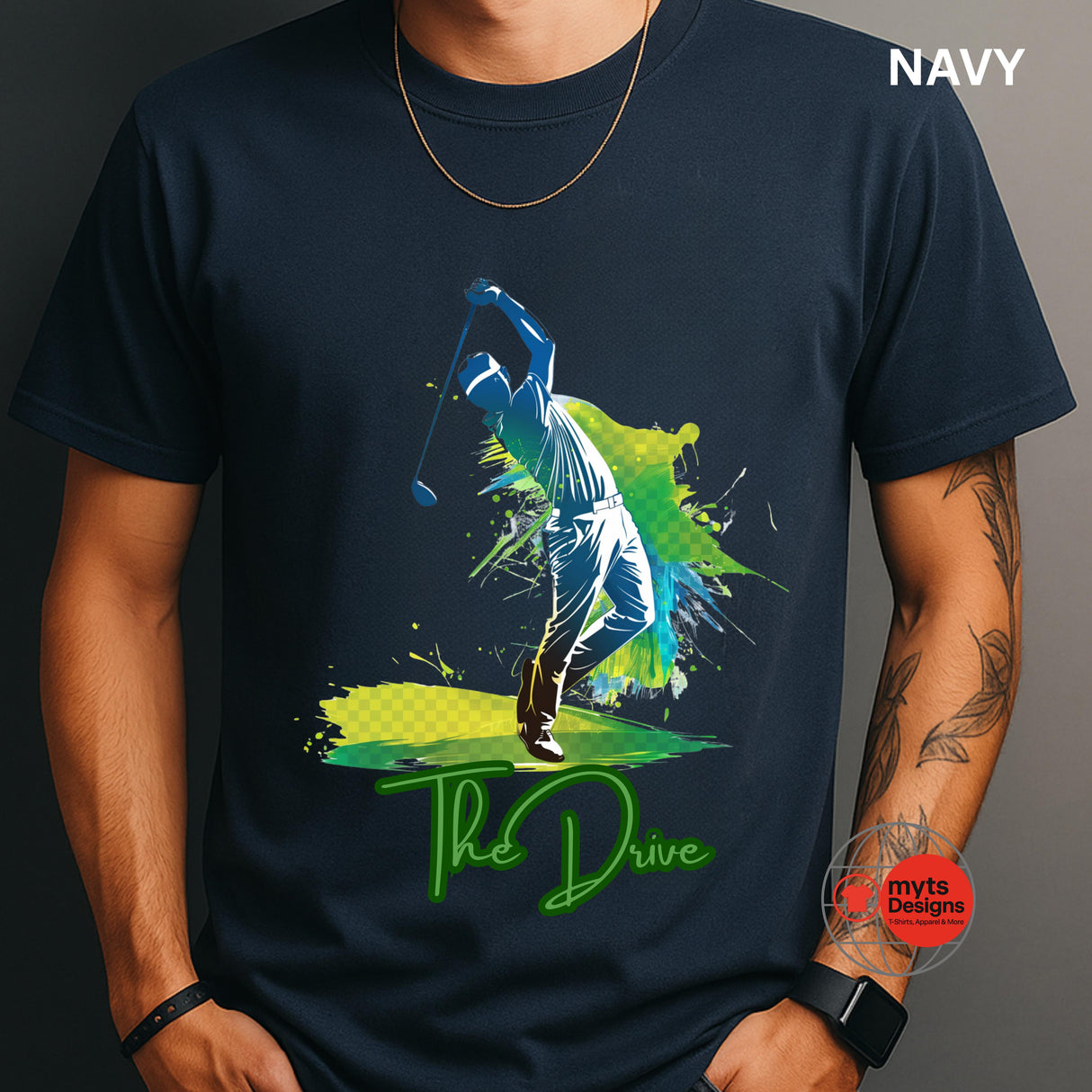Navy t-shirt with a colorful graphic of a golfer and 'The Drive' text, worn by a person.