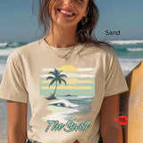 Woman wearing a t-shirt with a beach design on a beach