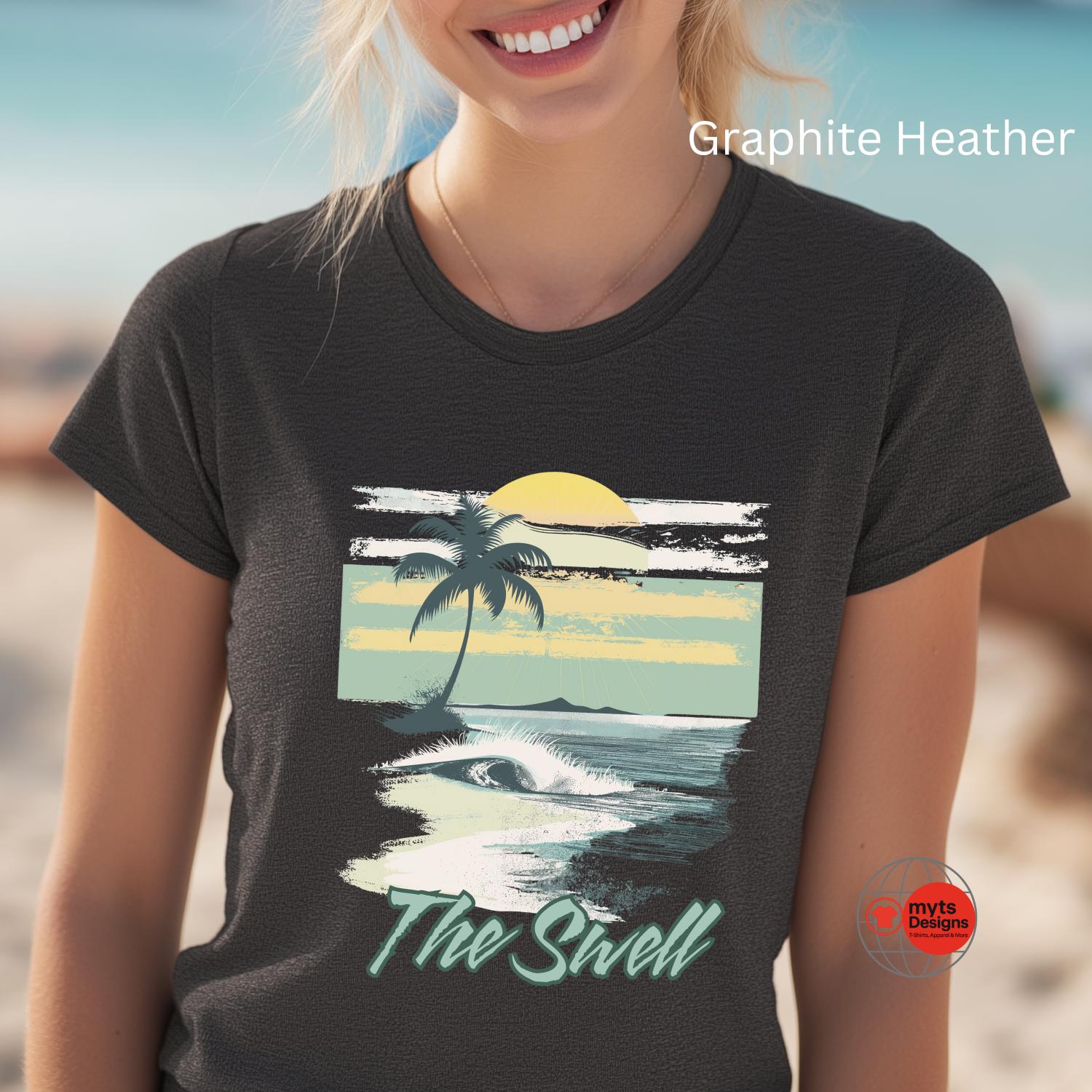 Person wearing a t-shirt with a beach graphic and 'The Swell' text on a blurred beach background.