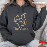 Dark Heather hoodie with 'The Vixen' logo worn by a person, sitting on a textured surface.