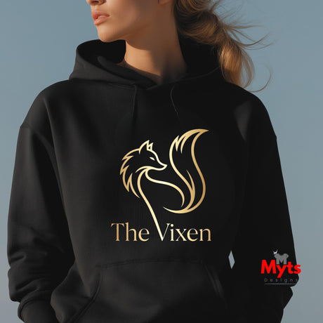 Black hoodie with gold 'The Vixen' logo worn by a person against a gray background