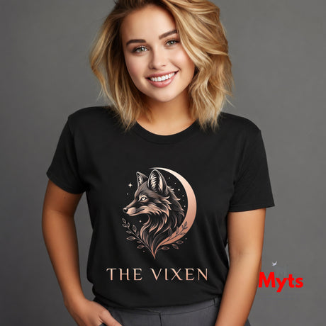 Woman wearing a black The Vixen Moon fox graphic T-shirt featuring a detailed celestial fox portrait, crescent moon, stars and botanical artwork.