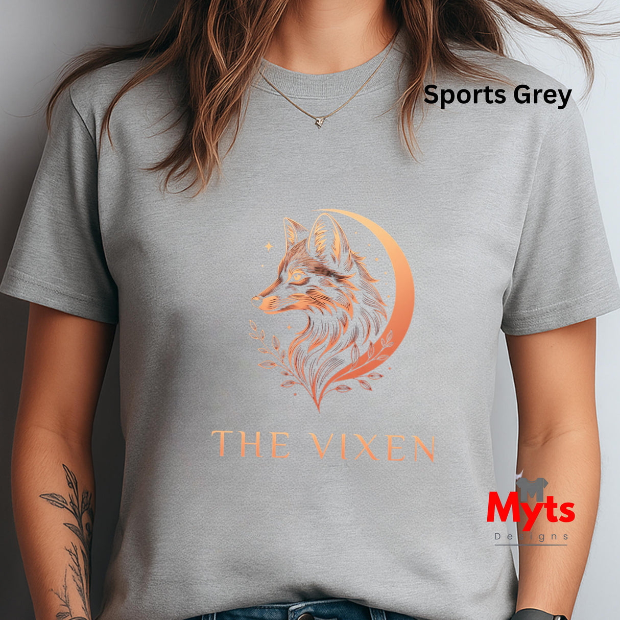 Woman wearing a Sports Grey The Vixen Moon fox graphic T-shirt featuring a detailed celestial fox portrait, crescent moon, stars and botanical artwork.