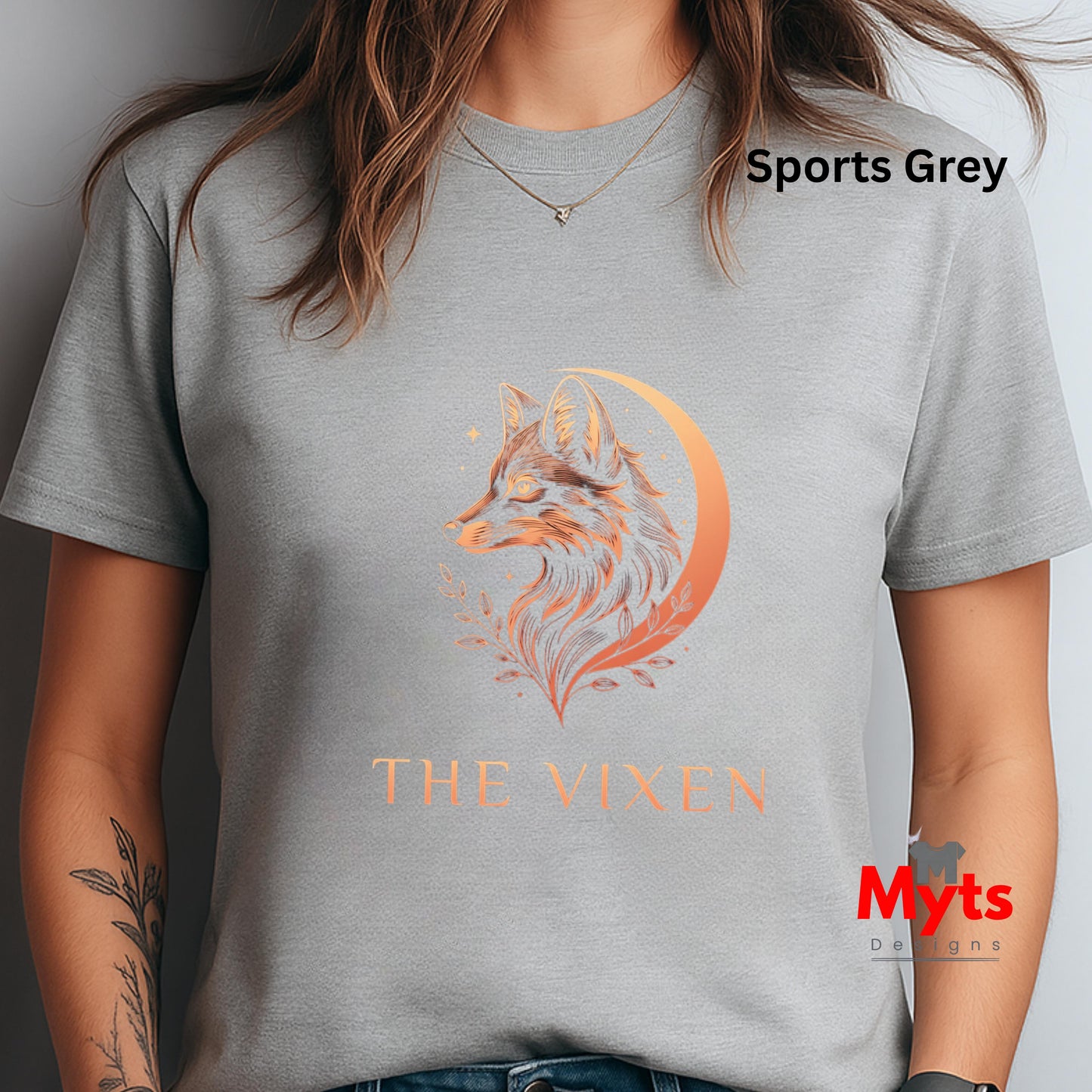 Woman wearing a Sports Grey The Vixen Moon fox graphic T-shirt featuring a detailed celestial fox portrait, crescent moon, stars and botanical artwork.