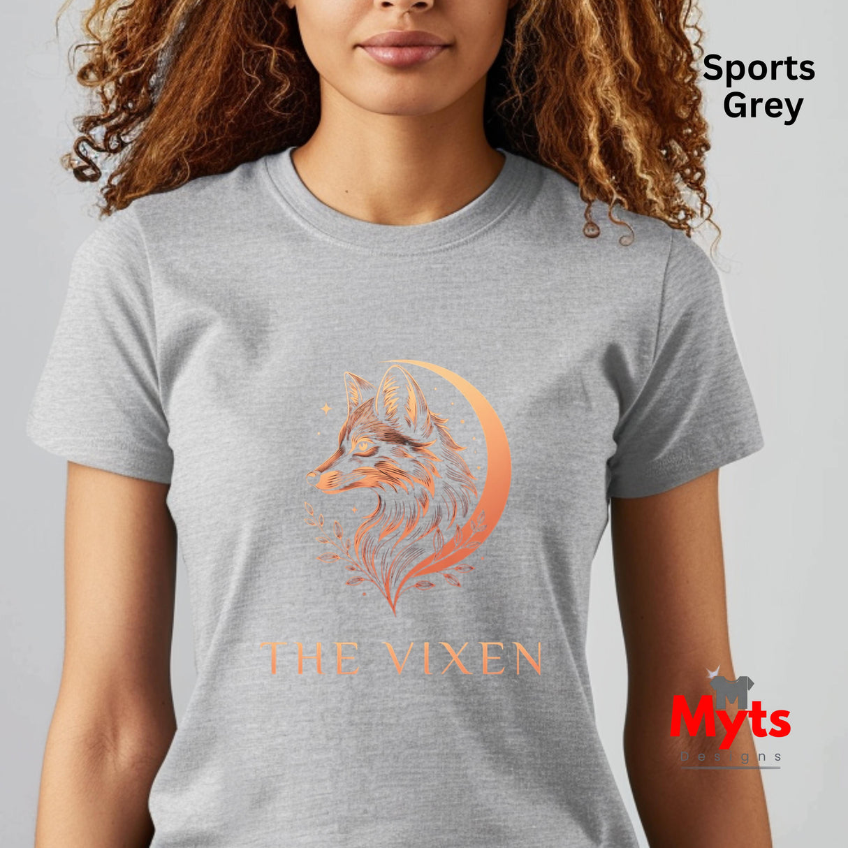 Woman wearing a Sports Grey The Vixen Moon fox graphic T-shirt featuring a detailed celestial fox portrait, crescent moon, stars and botanical artwork.