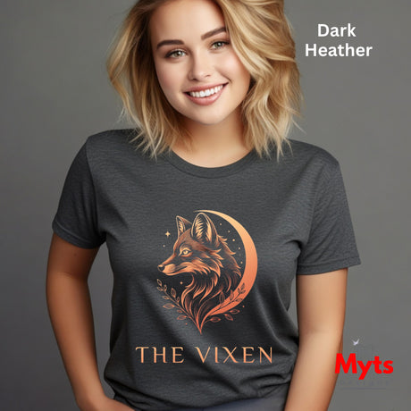 Woman wearing a Dark Heather The Vixen Moon fox graphic T-shirt featuring a detailed celestial fox portrait, crescent moon, stars and botanical artwork.