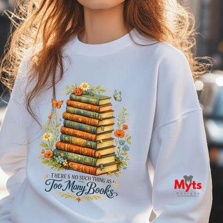 Person wearing a white sweatshirt with a book-themed design and 'Myts Designs' logo.
