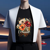 Woman wearing a black Unbound Beauty graphic T-shirt with red, orange and cream poppy flowers, geometric accents and retro typography.