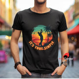Person wearing a black t-shirt with a colorful graphic and text, standing in an urban setting.