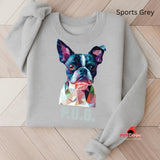 A sports grey sweatshirt displayed on a wooden surface featuring a vibrant polygon-style dog portrait with the text “P.U.G.” below, designed by MytsDesigns