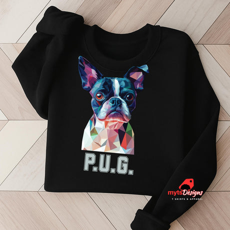 A black sweatshirt displayed on a wooden surface featuring a vibrant polygon-style dog portrait with the text “P.U.G.” below, designed by MytsDesigns