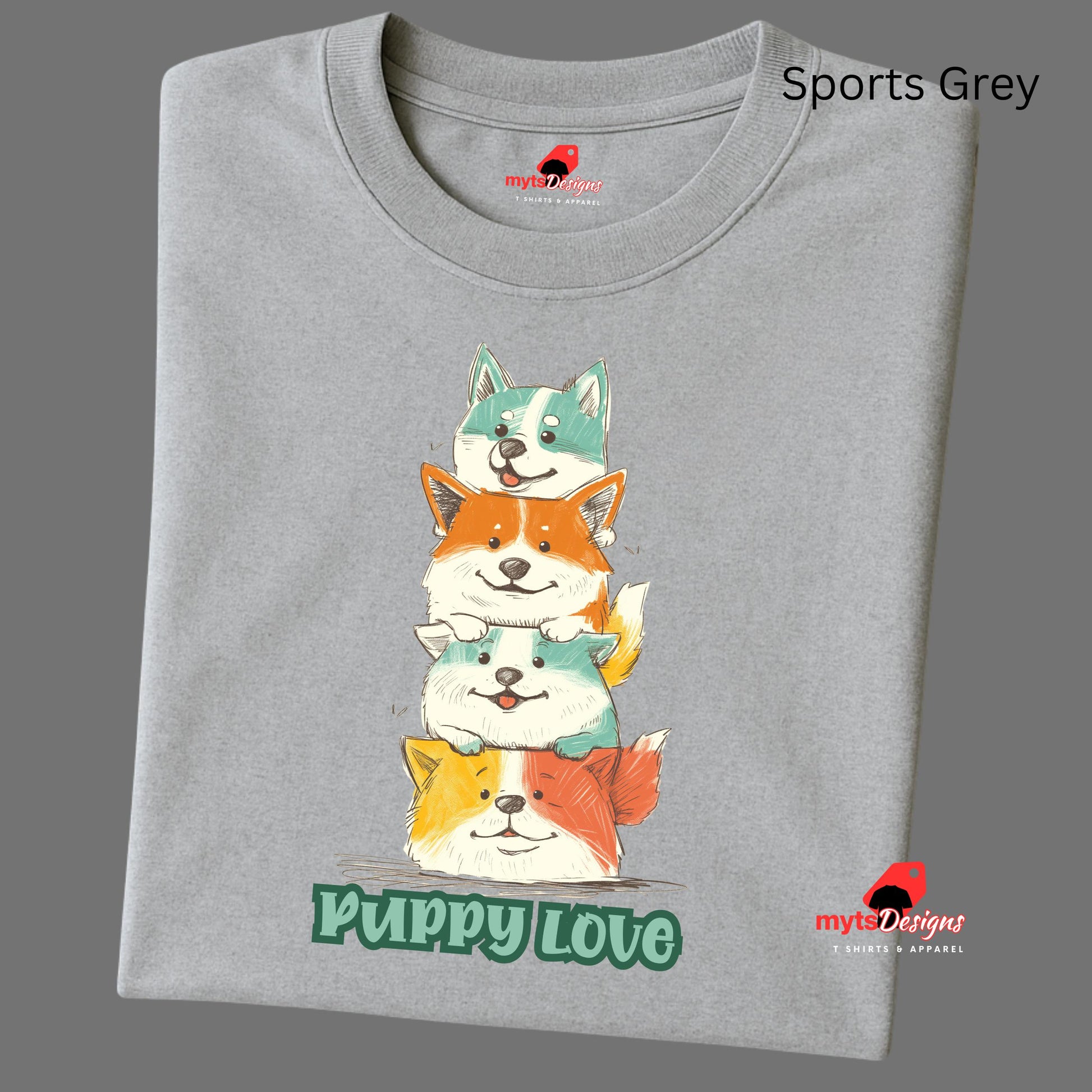 A folded sports grey T-shirt featuring a colorful graphic of four stacked cartoon puppies in teal, orange, cream, and yellow shades with the words “Puppy Love” in playful green text below

