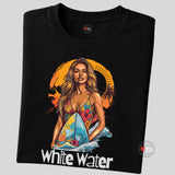 A folded black T-shirt featuring a vibrant illustration of a confident woman in a floral bikini holding a surfboard with ocean waves and an orange tropical sunset in the background. Below the graphic is the text “White Water.” 