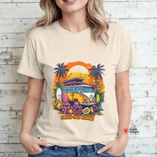 A woman wearing a beige T-shirt with a vibrant graphic of a retro yellow Kombi van, surfboards, tropical flowers, palm trees, and a bold orange sunset, styled with casual jeans.
