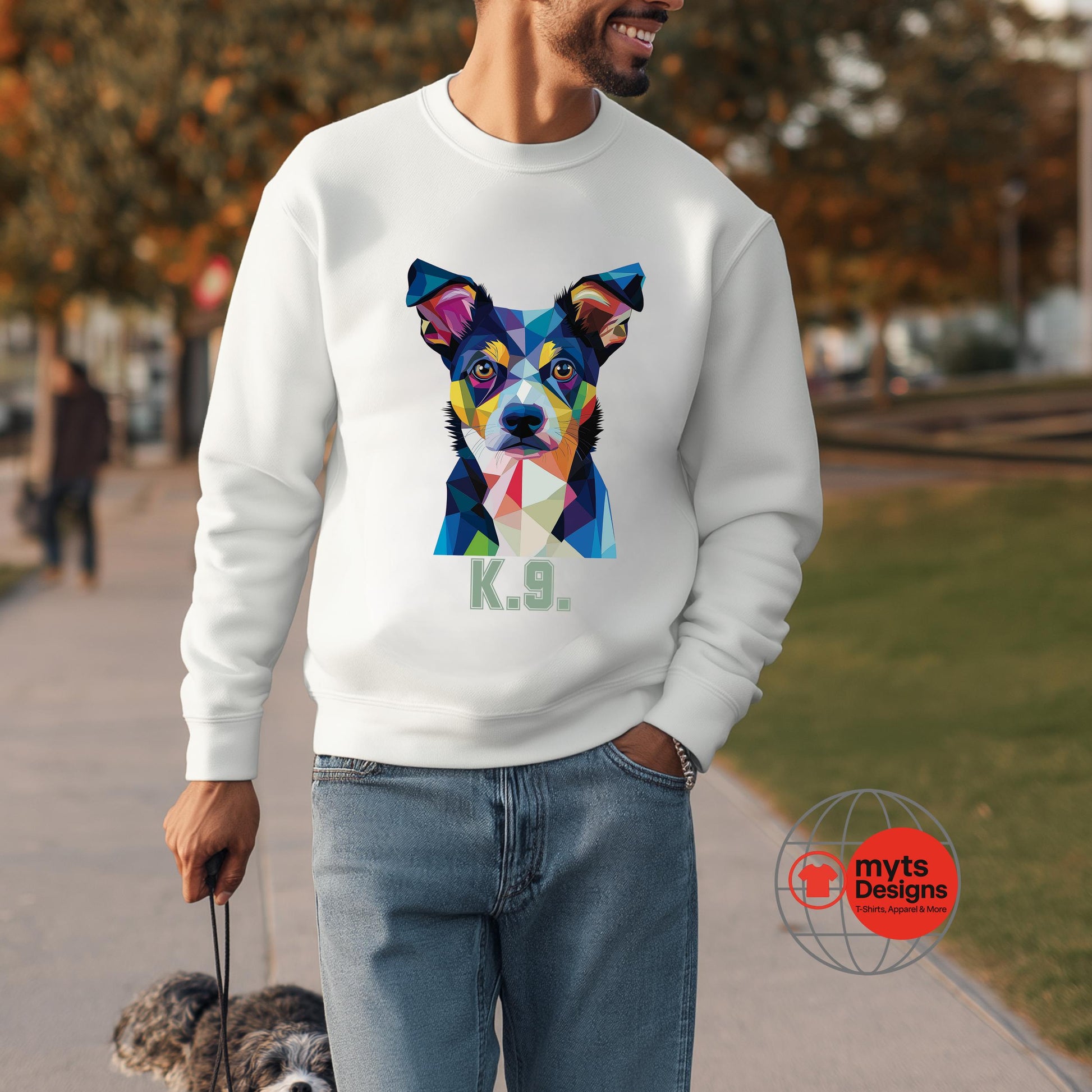 Person wearing a white sweatshirt with a colorful dog graphic and 'K9' text, standing outdoors.