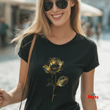 Woman wearing a black t-shirt with a gold rose design, standing outdoors.