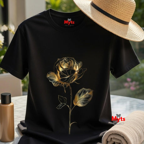 Black t-shirt with a gold rose design on a table outdoors, with 'Myts' branding.