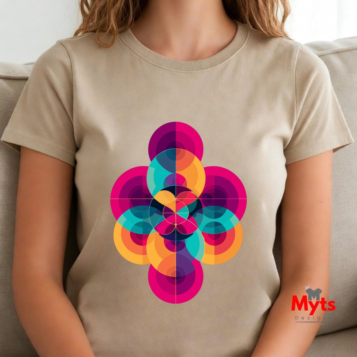 Person wearing a Natural (Beige) t-shirt with a colorful geometric design, sitting on a couch.