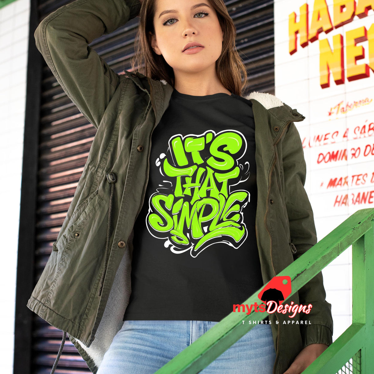 Girl standing on stairs wearing a black T-shirt featuring groovy 60s-style “It’s That Simple” psychedelic text design – printed on soft cotton