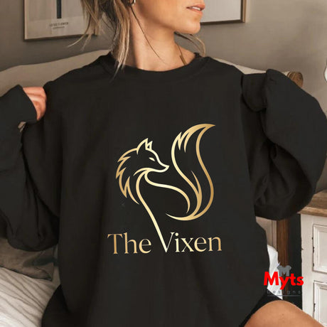 Person wearing a black sweatshirt with 'The Vixen' logo in gold.