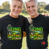 Two men wearing black t-shirts with 'Going Golfing' graphic design on a golf course background.