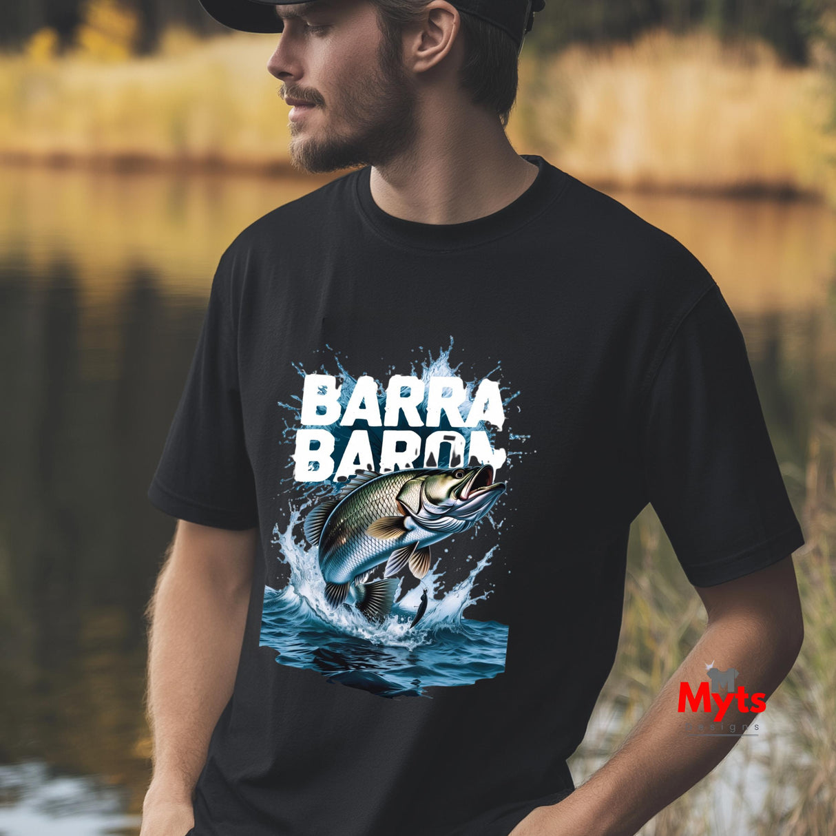 Man wearing a black t-shirt with a fish graphic and 'BARRA BARRA' text, standing outdoors by a body of water.