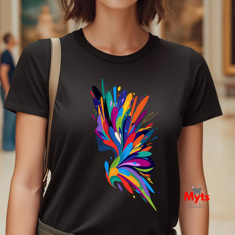 Person wearing a black t-shirt with a colorful abstract design, standing indoors.