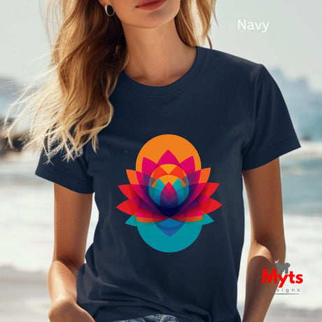 Person wearing a navy t-shirt with a colorful flower design, sitting by a body of water.