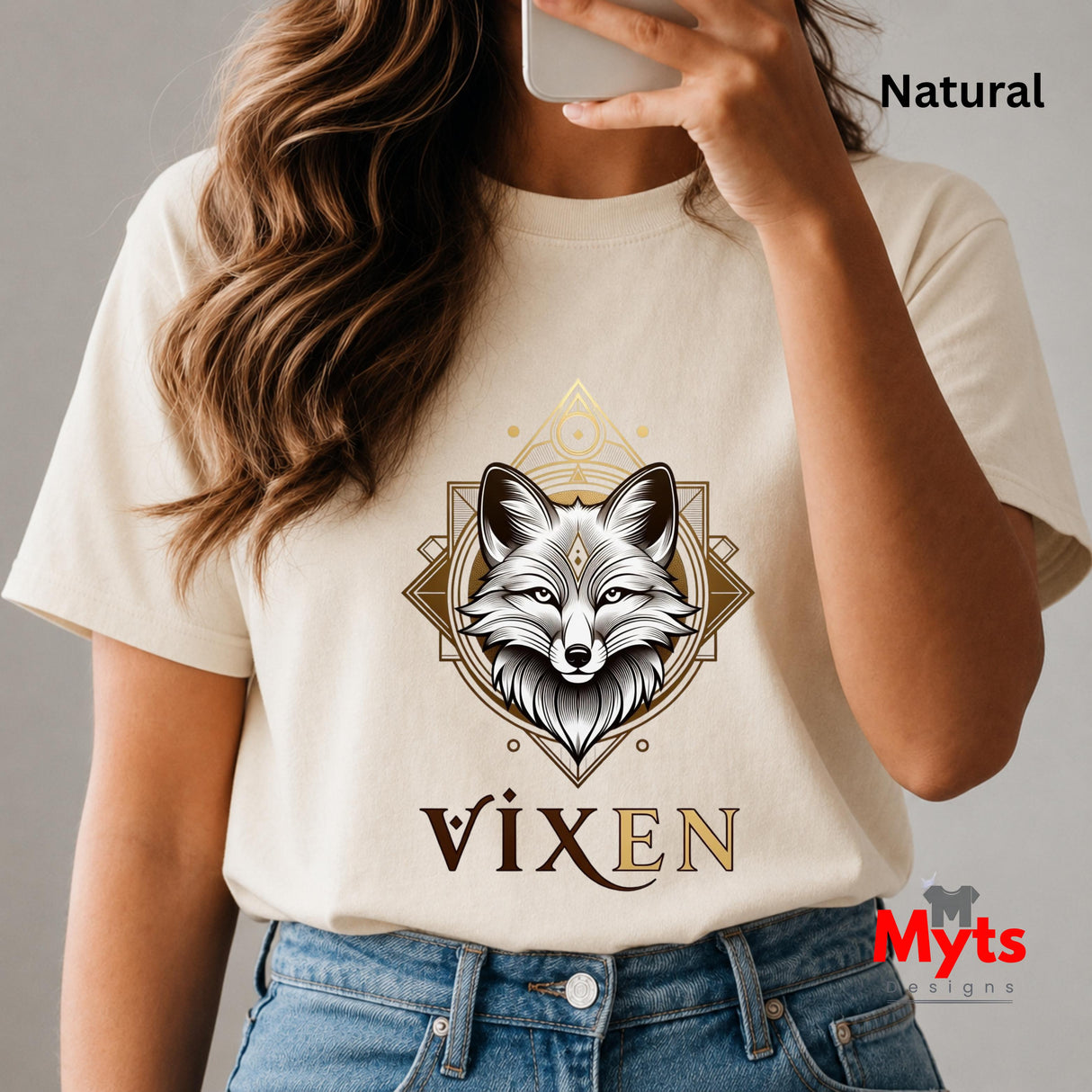 Person wearing a Natural t-shirt with a fox graphic and 'Vixen' text, holding a phone.