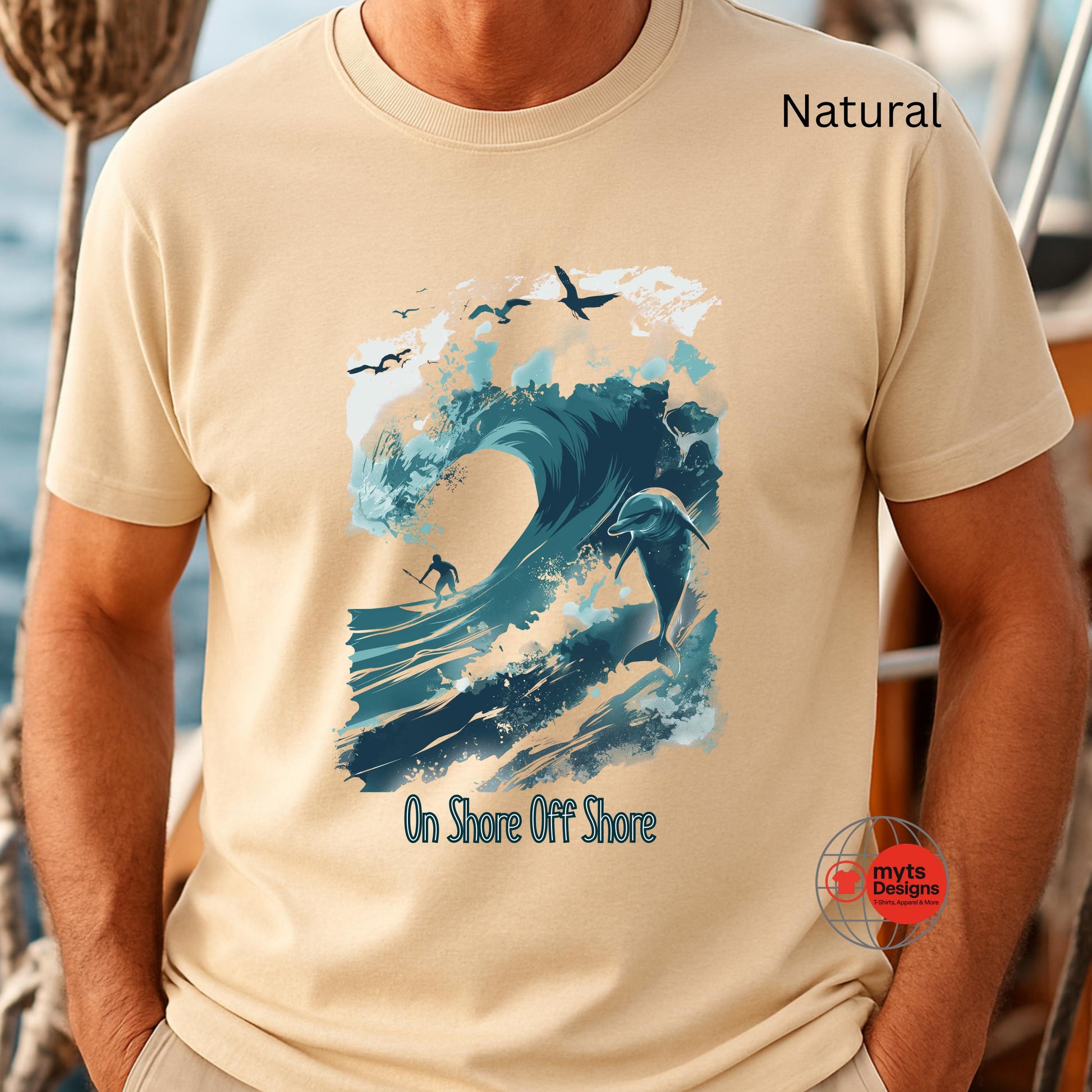 Natural t-shirt with a graphic design of a surfer and ocean waves, worn by a person on a boat.
