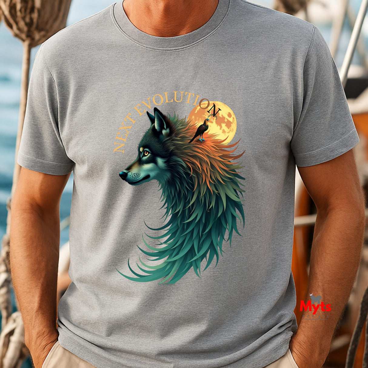 A man wearing a heather gray t-shirt with a detailed graphic of a wolf's head in profile, blending teal, blue, and orange tones, with a full moon and the words 'WOLF EVOLUTION' behind it.