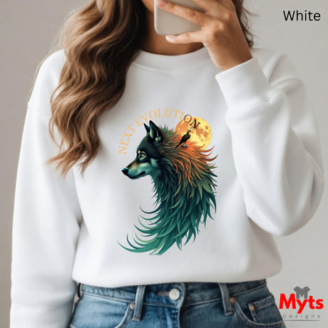 A person wearing a white crewneck sweatshirt with a colorful graphic of a wolf's head in profile, blending teal, green, orange, and yellow tones, with the text 'NEXT EVOLUTION' above it. The person is holding a phone to take a mirror selfie, with blue jeans visible at the bottom.