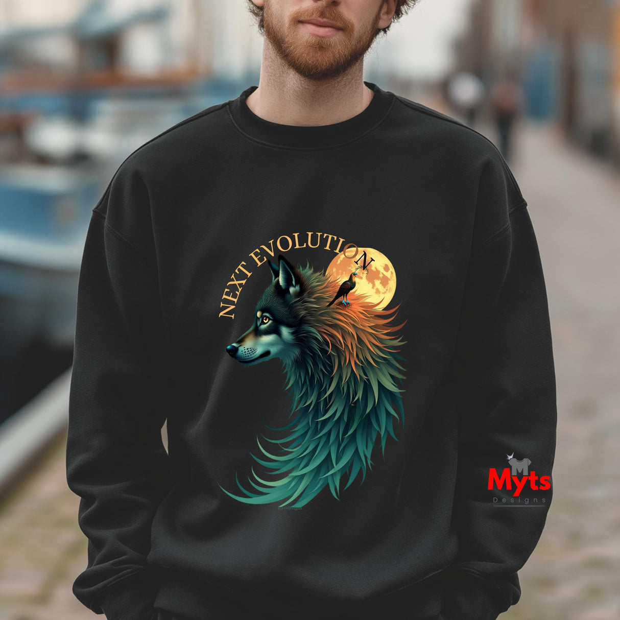 A man wearing a black crewneck sweatshirt with a colorful graphic of a wolf and crow around a full moon with the text 'NEXT EVOLUTION'.