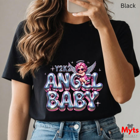 Person wearing a black t-shirt with 'Y2K2 Angel Baby' design, holding a phone.