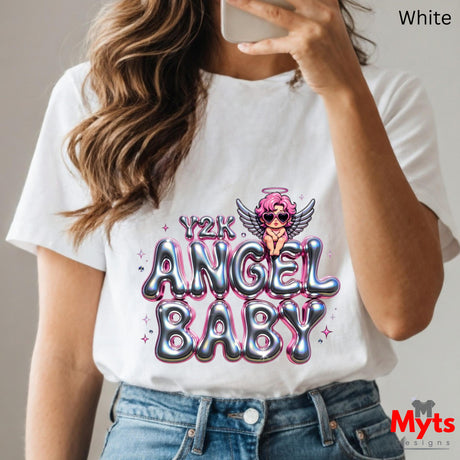 Person wearing a white t-shirt with 'Y2K Angel Baby' design, holding a phone.