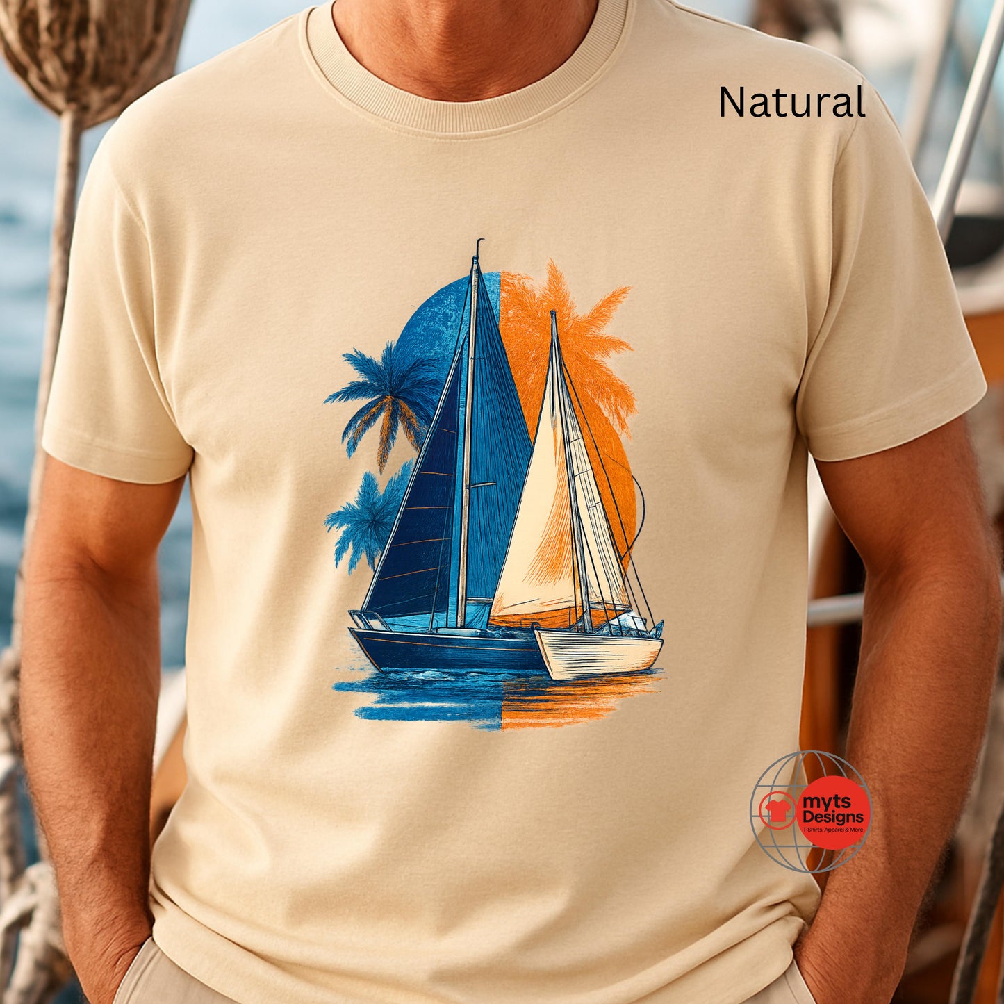 Natural t-shirt with a sailboat and palm tree design, worn by a person.