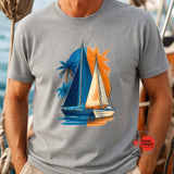 Person wearing a gray t-shirt with a sailboat and palm tree design.