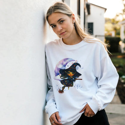 Woman wearing a white sweatshirt with a colorful witch graphic on a street.