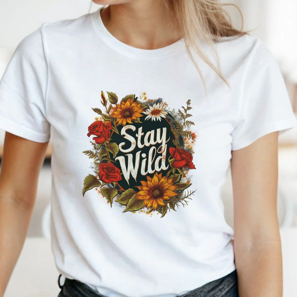 Woman wearing a soft white t-shirt with a stylish boho "Stay Wild" graphic design, perfect for nature lovers.
