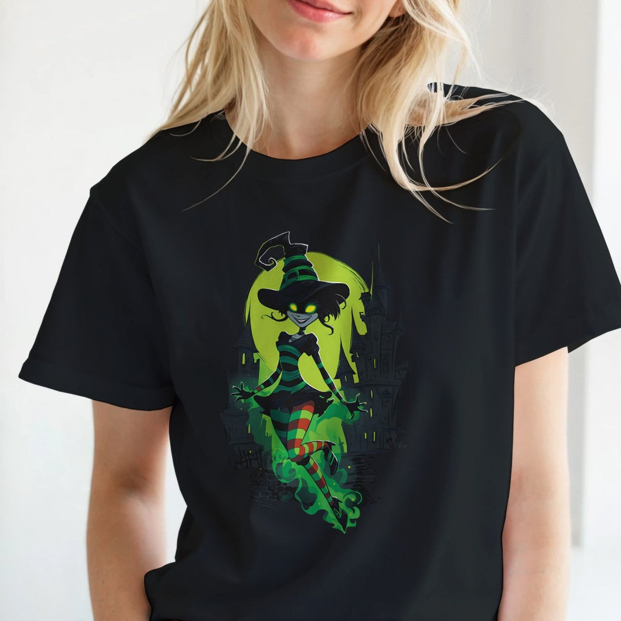 Person wearing a black t-shirt with a colorful graphic design, standing indoors.