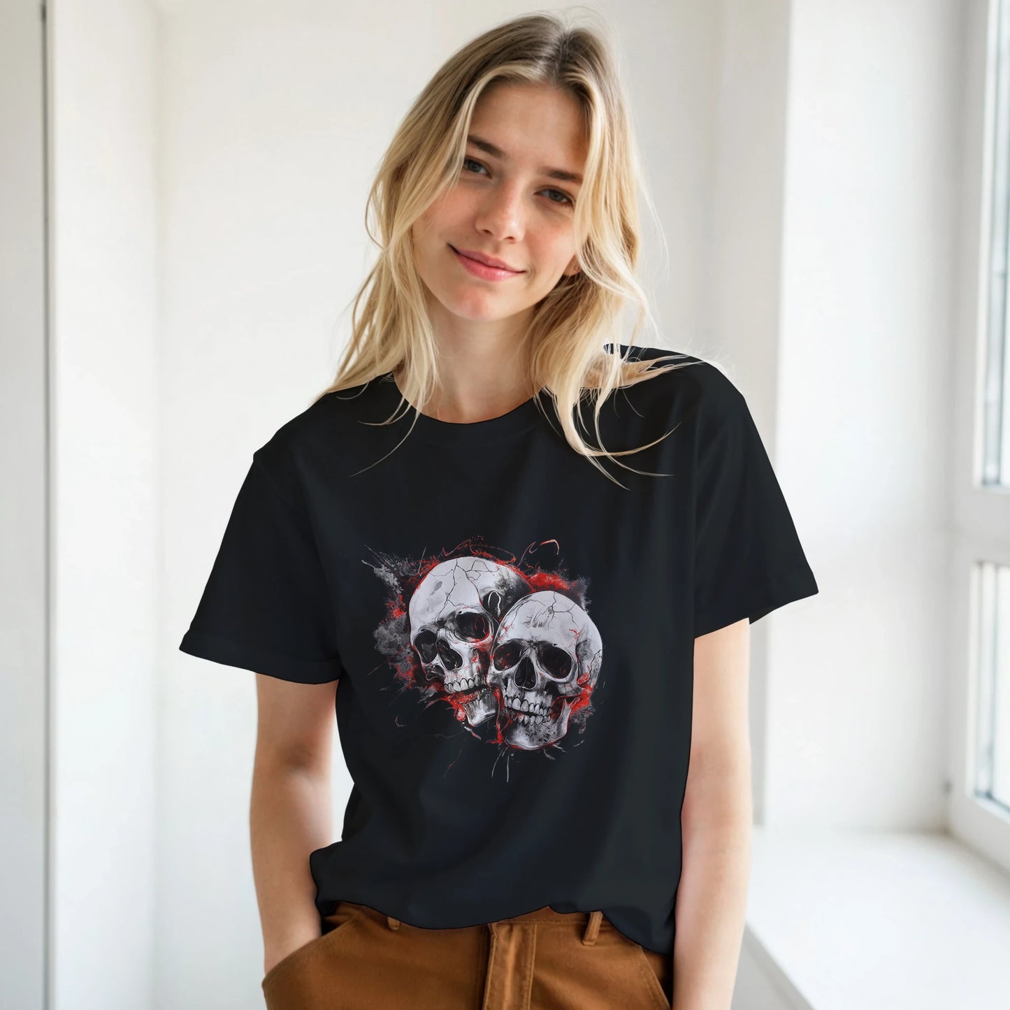 Woman wearing a black t-shirt with a skull design in a bright room.