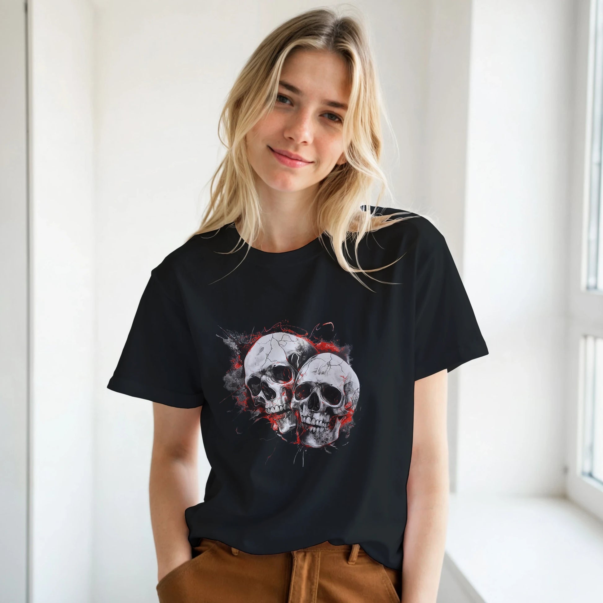 Woman wearing a black t-shirt with a skull design in a bright room.