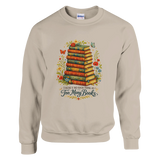 Sand sweatshirt featuring vintage stacked books artwork with floral accents and “There’s No Such Thing As Too Many Books” text.