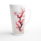 A tall white ceramic latte mug featuring a watercolor-style print of a cherry blossom tree with pink flowers and a dark brown branch, set against a clean white background.