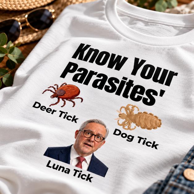 Close-up of white political satire T-shirt featuring Deer Tick, Dog Tick and Luna Tick labels with illustrated graphics.
