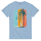 Light blue t-shirt with a tropical design featuring palm trees and a surfboard on a white background.