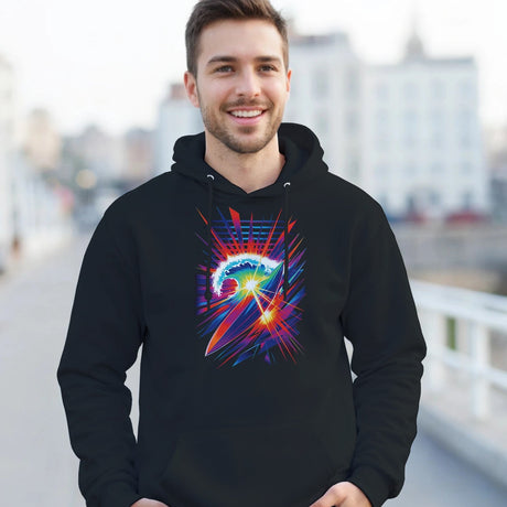 Man wearing a black hoodie with a colorful graphic design outdoors.